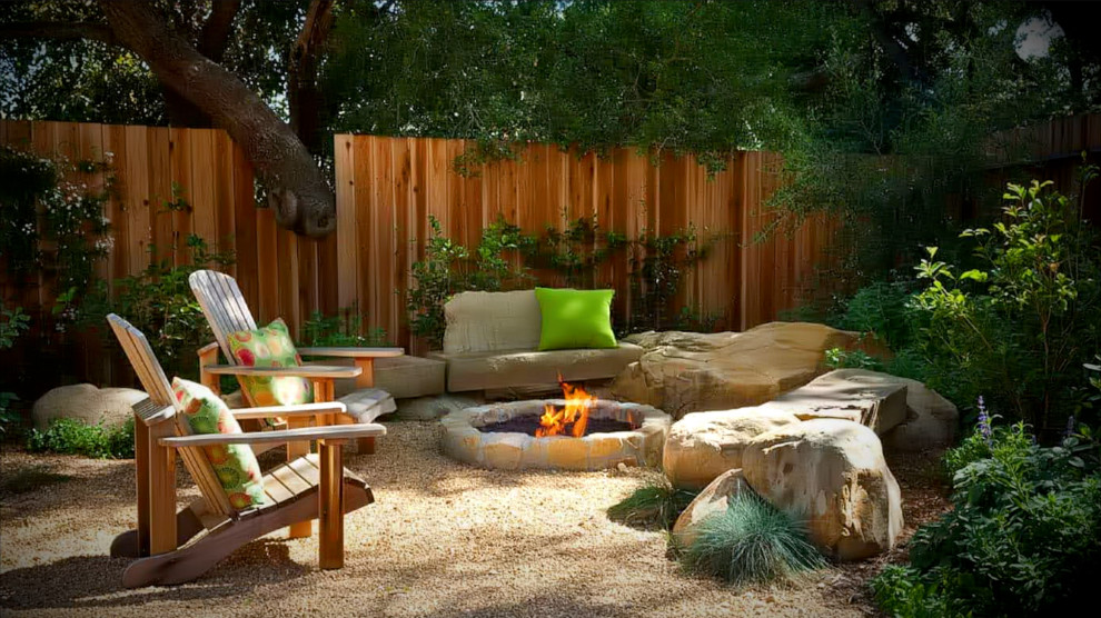 Inspiration for a small country backyard partial sun xeriscape for fall in Austin with a fire feature and decomposed granite.