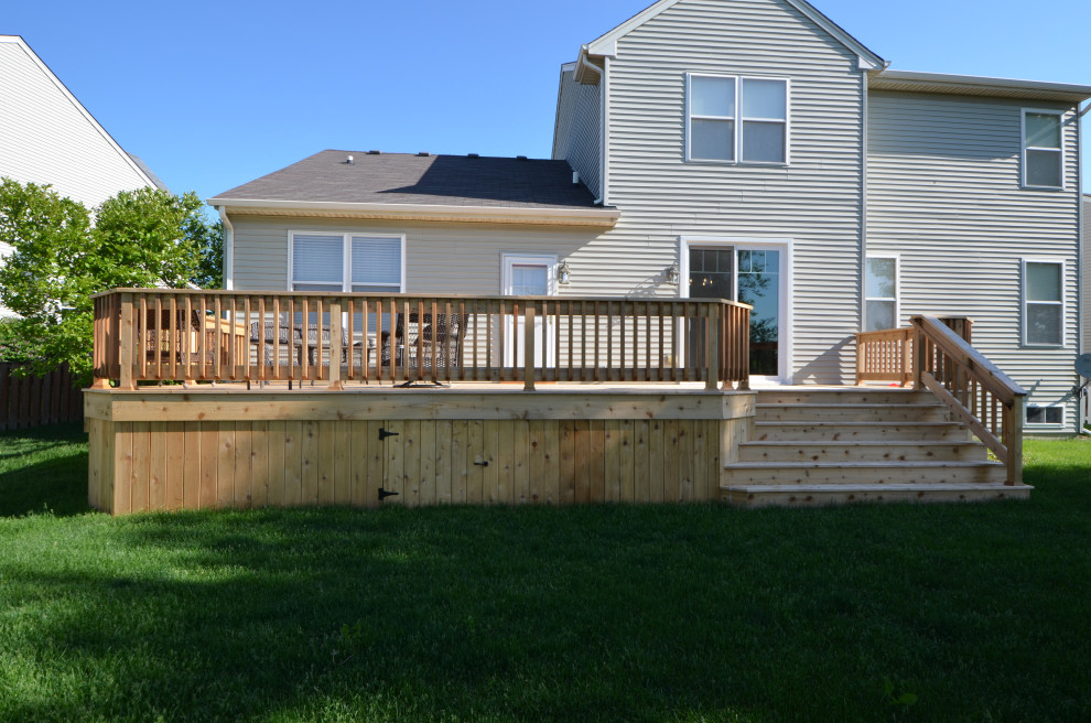 Mid-sized elegant backyard deck photo with no cover
