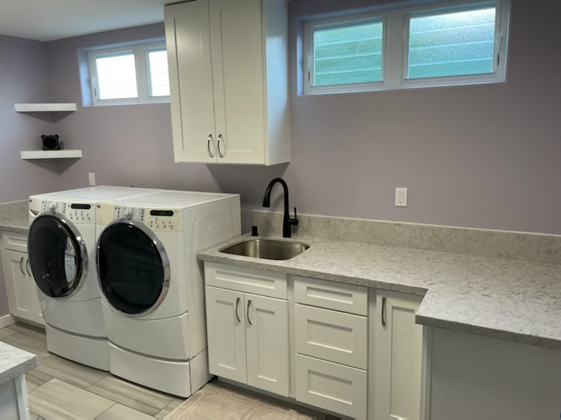 Inspiration for a laundry room in Hawaii with a single-bowl sink, shaker cabinets, white cabinets, quartzite benchtops, purple walls, ceramic floors and a side-by-side washer and dryer.