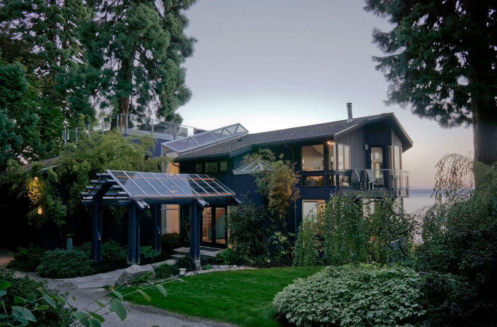 Mid-sized contemporary two-storey grey house exterior in Seattle with concrete fiberboard siding, a gable roof and a shingle roof.