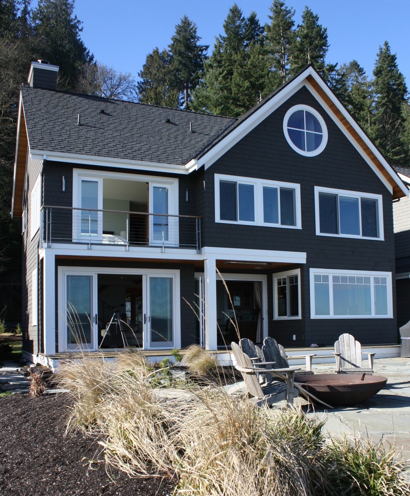 Inspiration for a mid-sized coastal green two-story wood gable roof remodel in Seattle