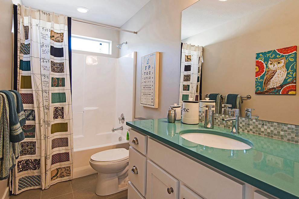 Traditional kids bathroom in Salt Lake City with white cabinets, quartzite benchtops, a drop-in tub, a corner shower, white tile, ceramic tile, beige walls, ceramic floors and turquoise benchtops.