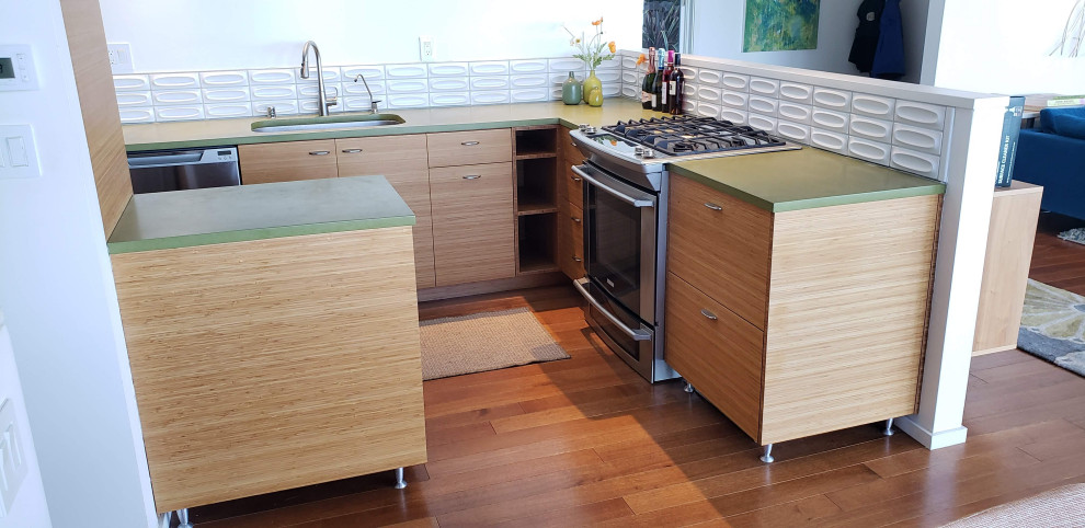 Photo of a small midcentury l-shaped open plan kitchen in San Francisco with an undermount sink, flat-panel cabinets, medium wood cabinets, concrete benchtops, white splashback, subway tile splashback, stainless steel appliances, medium hardwood floors, a peninsula, brown floor, green benchtop and exposed beam.