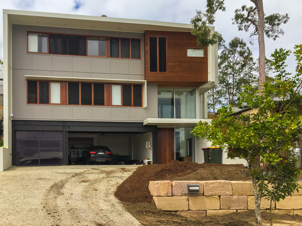 Large modern split-level exterior in Brisbane with concrete fiberboard siding.