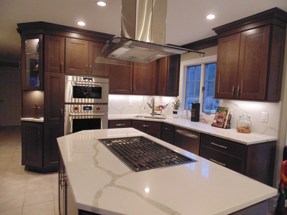 Eat-in kitchen - mid-sized transitional u-shaped ceramic tile and beige floor eat-in kitchen idea with an undermount sink, recessed-panel cabinets, dark wood cabinets, quartz countertops, white backsplash, stone slab backsplash, stainless steel appliances, an island and white countertops