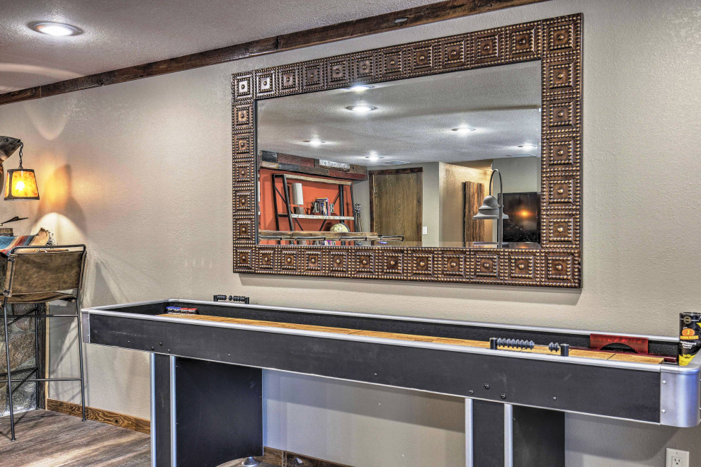 Basement - mid-sized rustic walk-out vinyl floor and brown floor basement idea with multicolored walls, a standard fireplace and a metal fireplace