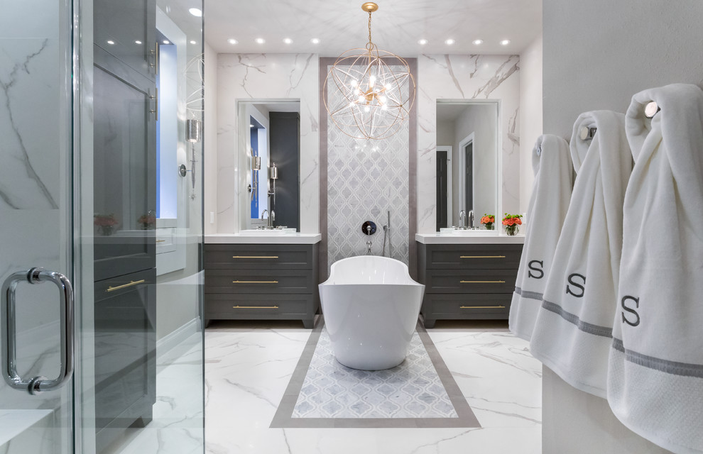 Mid-sized transitional master bathroom in Houston with grey cabinets, a freestanding tub, a curbless shower, a wall-mount toilet, white tile, porcelain tile, grey walls, marble floors, a vessel sink, quartzite benchtops and shaker cabinets.