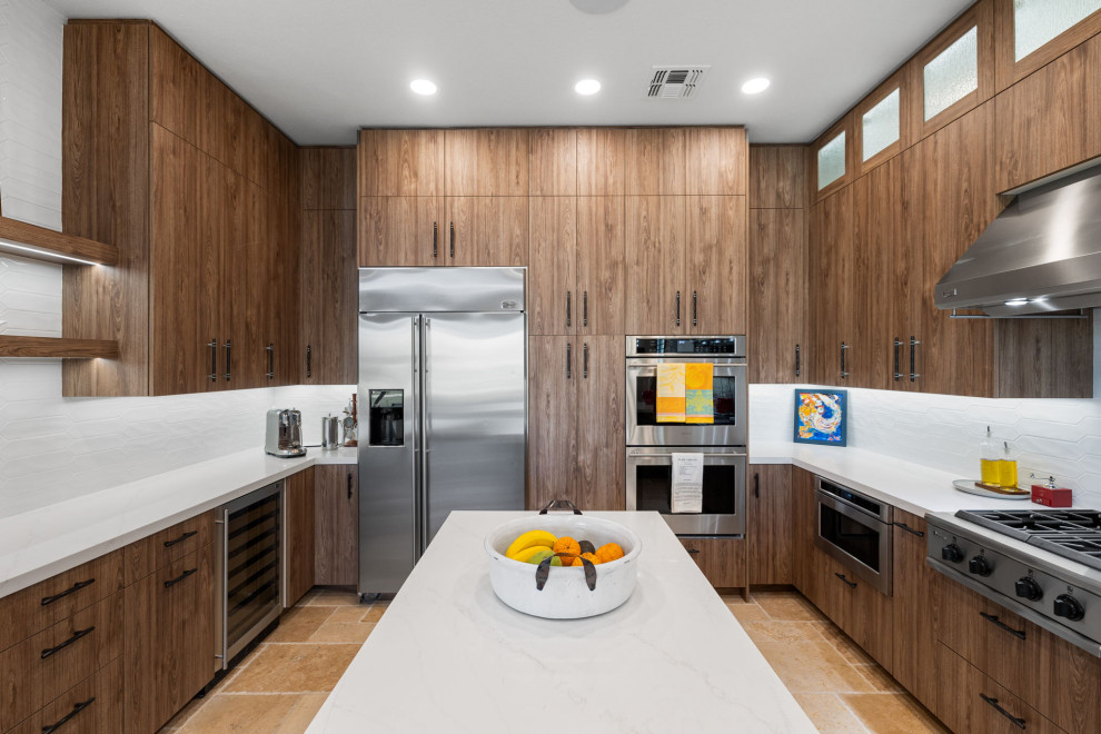 Mountain style l-shaped slate floor and beige floor enclosed kitchen photo with a single-bowl sink, flat-panel cabinets, medium tone wood cabinets, quartzite countertops, white backsplash, glass sheet backsplash, stainless steel appliances, a peninsula and white countertops