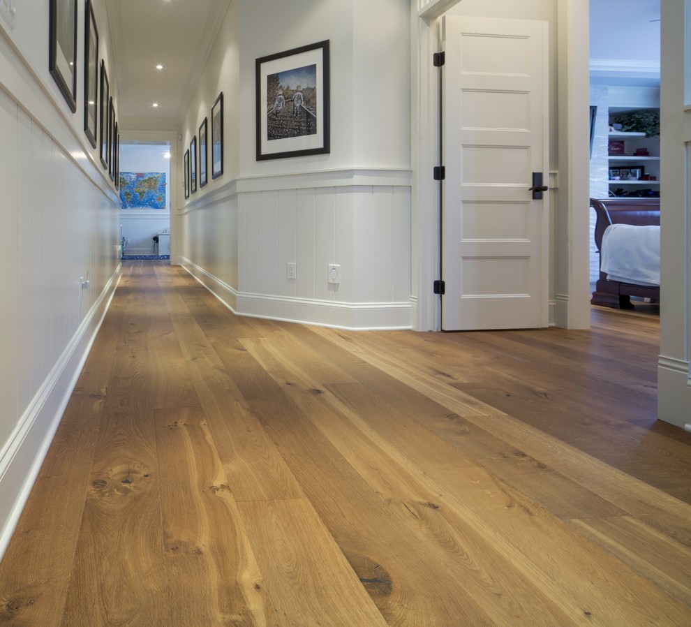 Inspiration for a transitional hallway in Calgary with light hardwood floors.