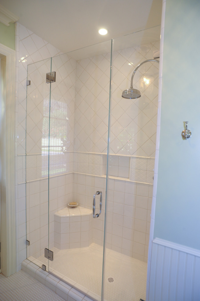 This is an example of a mid-sized traditional bathroom in Phoenix with raised-panel cabinets, white cabinets, a double shower, a two-piece toilet, white tile, cement tile, green walls, ceramic floors, a drop-in sink and tile benchtops.