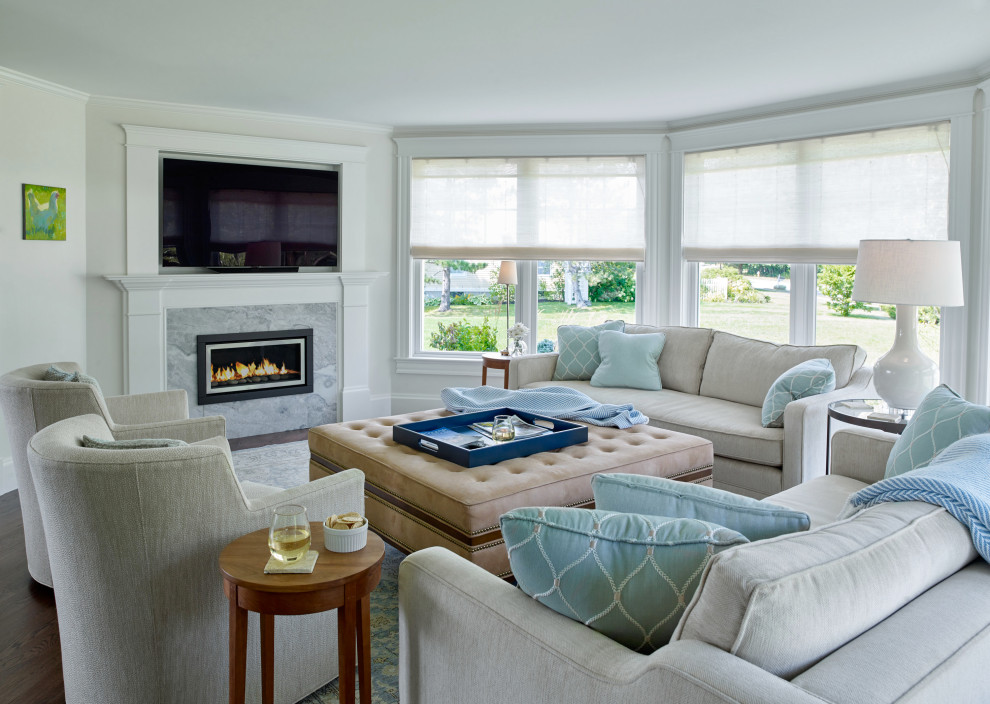 Photo of a beach style living room in Portland Maine with beige walls, dark hardwood floors, a standard fireplace, a wall-mounted tv and brown floor.