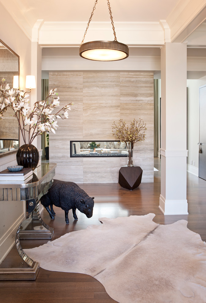 Inspiration for a transitional medium tone wood floor and brown floor foyer remodel in Calgary with white walls