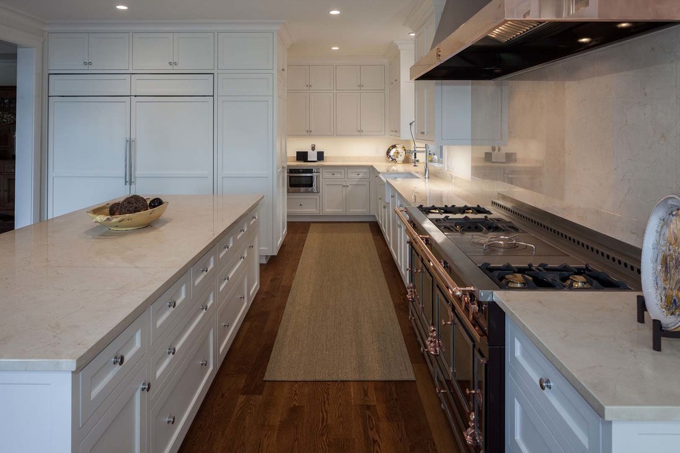 Large transitional light wood floor kitchen photo with a drop-in sink, recessed-panel cabinets, white cabinets, marble countertops, glass tile backsplash and stainless steel appliances