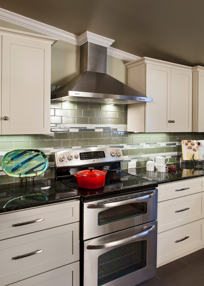 Large elegant u-shaped ceramic tile open concept kitchen photo in Charlotte with a drop-in sink, shaker cabinets, white cabinets, granite countertops, green backsplash, glass tile backsplash, stainless steel appliances and no island