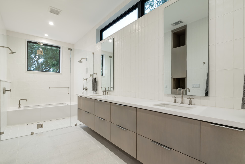 Photo of a large scandinavian master wet room bathroom in Austin with flat-panel cabinets, grey cabinets, an undermount tub, a one-piece toilet, white tile, white walls, an undermount sink, white floor, a hinged shower door, white benchtops and engineered quartz benchtops.