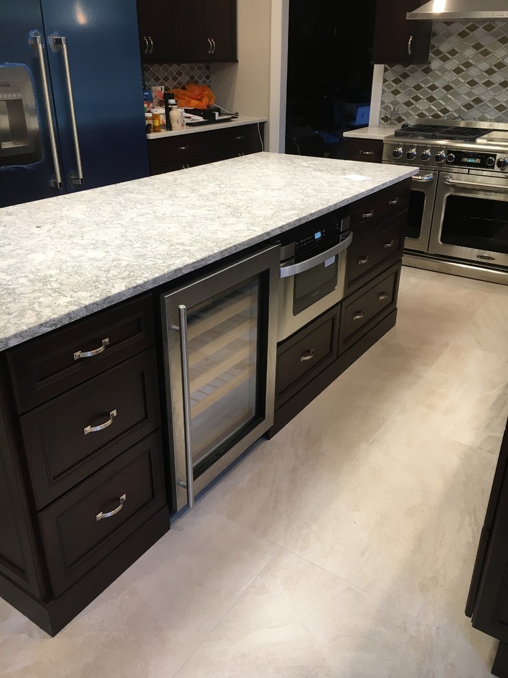 Kitchen - mid-sized transitional porcelain tile and beige floor kitchen idea in New York with beaded inset cabinets, black cabinets, quartzite countertops, multicolored backsplash, ceramic backsplash, stainless steel appliances and an island