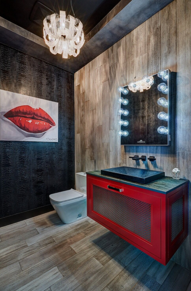 Large eclectic powder room in Sacramento with shaker cabinets, red cabinets, a one-piece toilet, wood-look tile, black walls, a drop-in sink, engineered quartz benchtops, a floating vanity, wallpaper, brown tile, wood-look tile, brown floor and green benchtops.