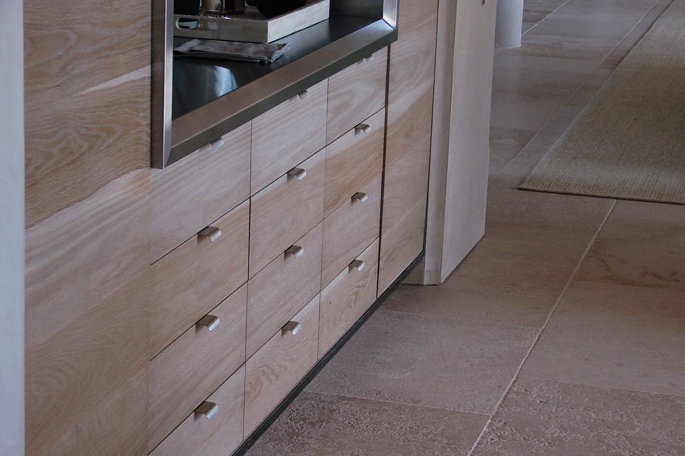 Large transitional single-wall travertine floor open concept kitchen photo in Charlotte with an undermount sink, light wood cabinets, limestone countertops, stainless steel appliances and two islands