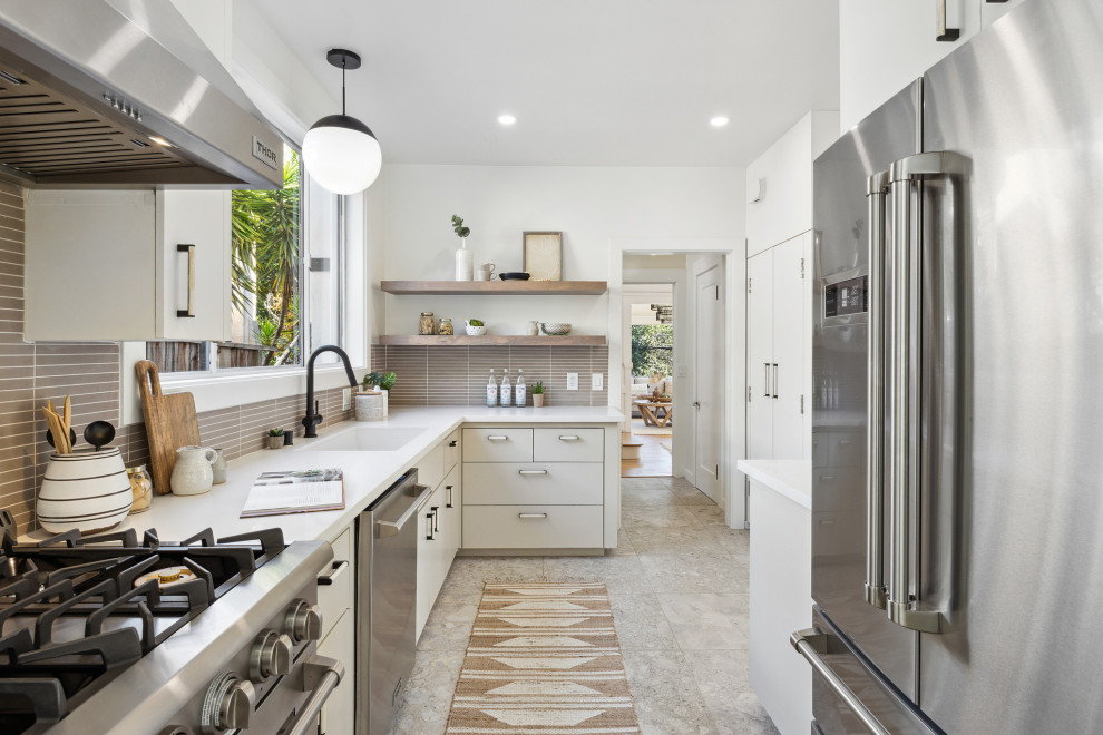 Mid-sized contemporary l-shaped separate kitchen in San Francisco with an undermount sink, flat-panel cabinets, beige cabinets, quartz benchtops, beige splashback, porcelain splashback, stainless steel appliances, porcelain floors, beige floor and white benchtop.