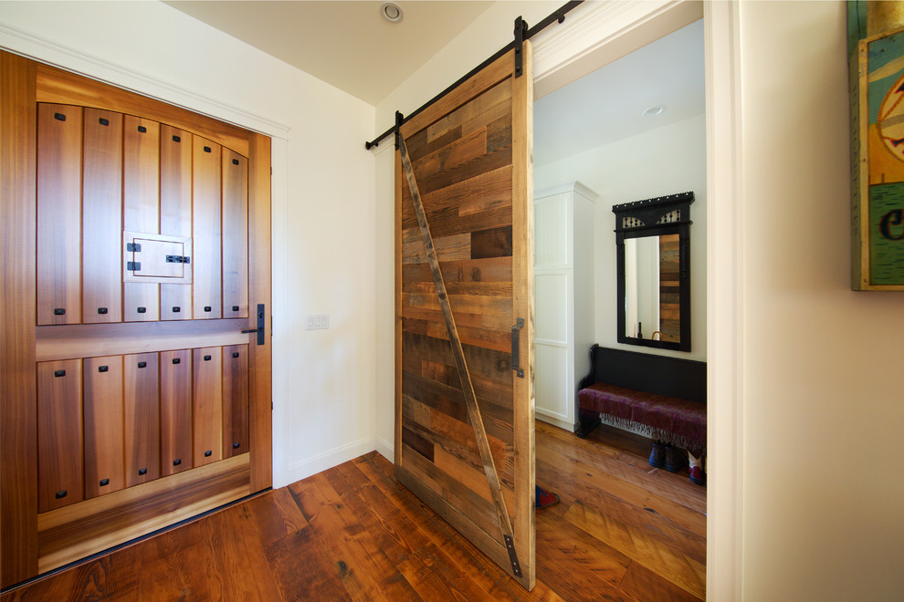 Foyer - mid-sized rustic medium tone wood floor foyer idea in Vancouver with white walls and a medium wood front door