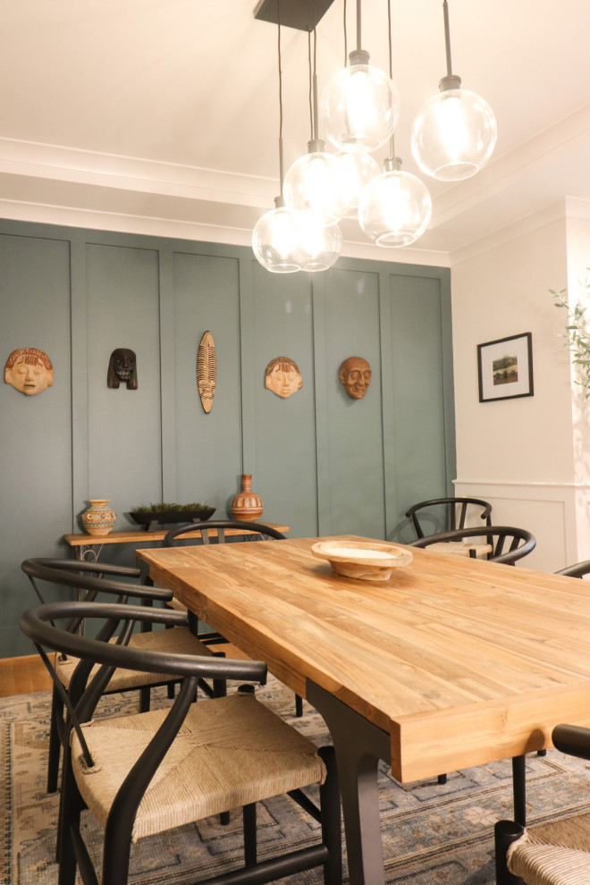 Large modern open plan dining room in DC Metro with blue walls, light hardwood flooring, no fireplace, brown floors, a coffered ceiling and wainscoting.