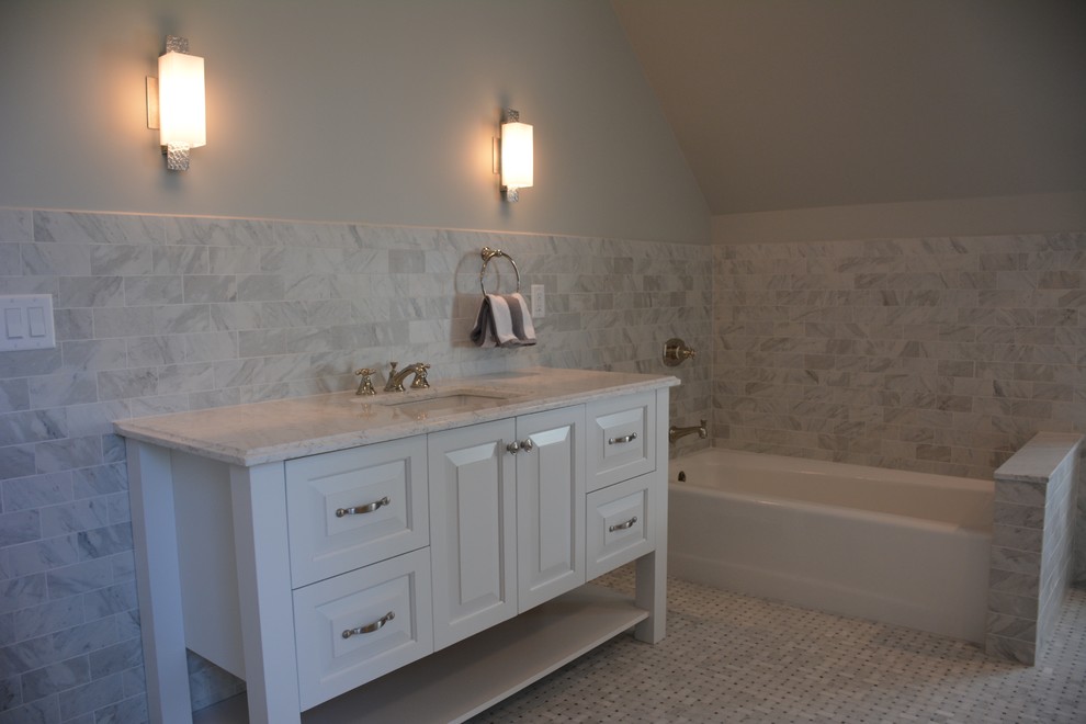 Design ideas for a mid-sized contemporary master bathroom in New York with raised-panel cabinets, white cabinets, a corner tub, marble, grey walls, an undermount sink and marble benchtops.