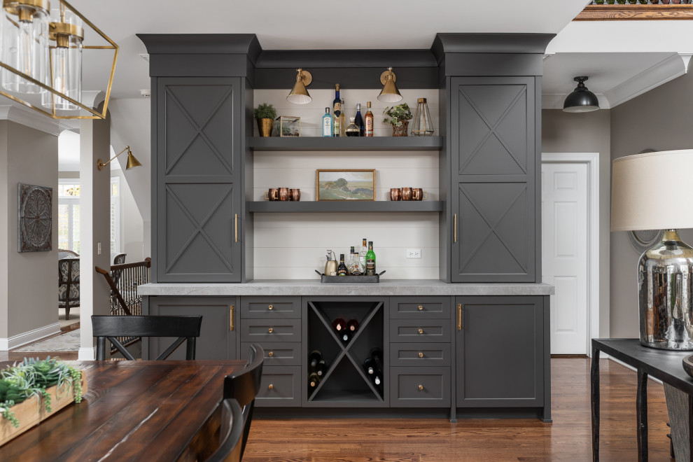 Inspiration for a large transitional single-wall home bar in Chicago with grey cabinets, quartz benchtops, marble splashback, dark hardwood floors, brown floor, white benchtop and shaker cabinets.