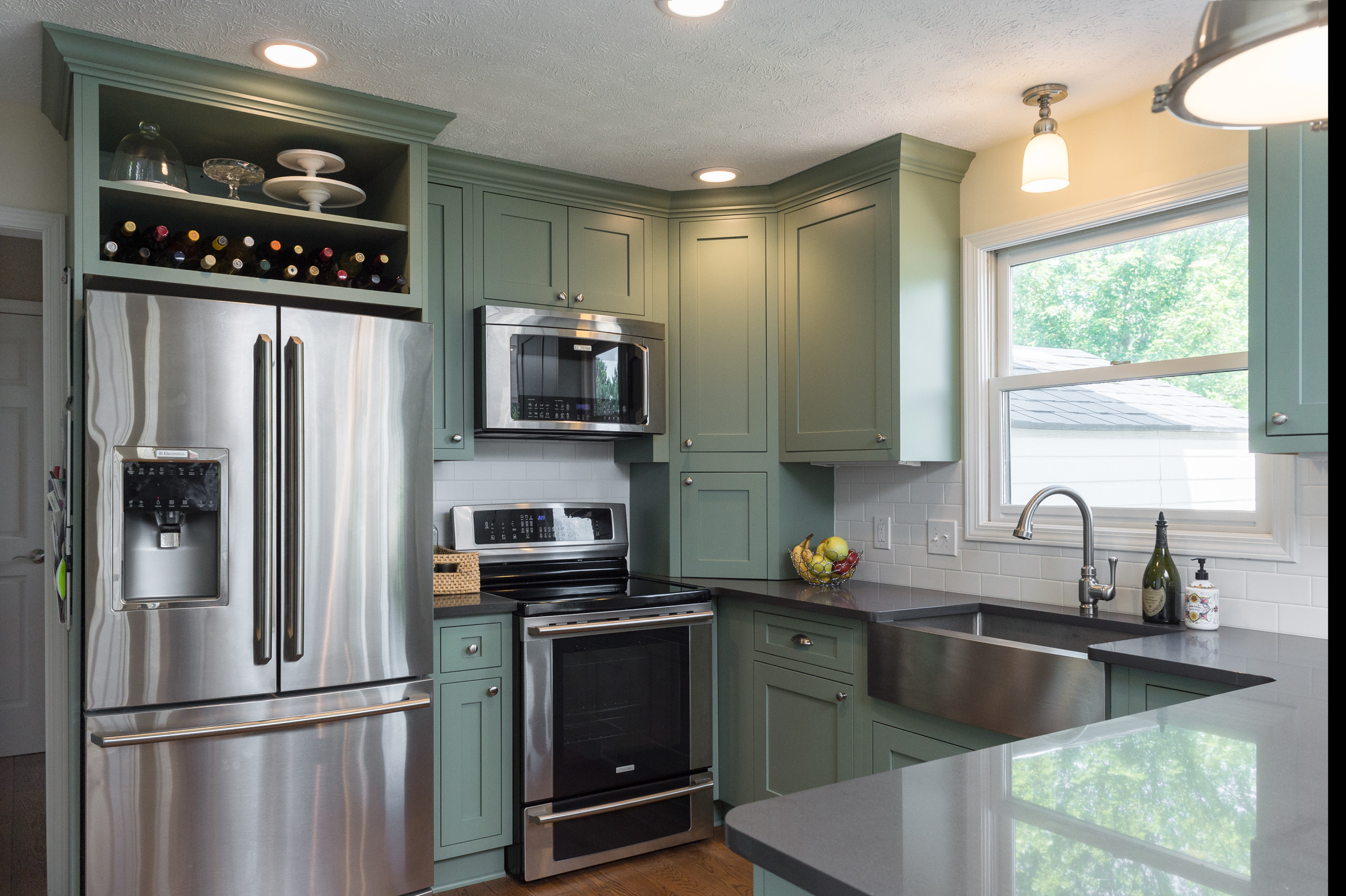 Sage Green Kitchen Cabinets With Stainless Steel Appliances: Chic Harmony