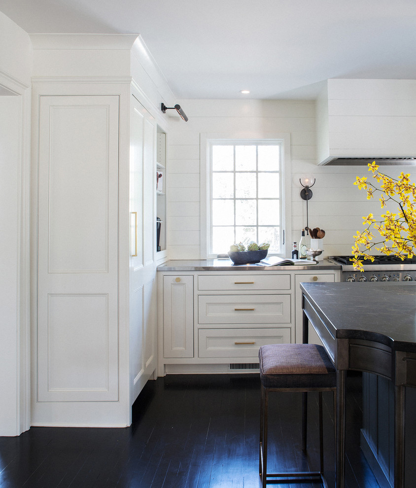 Inspiration for a large transitional u-shaped dark wood floor enclosed kitchen remodel with an undermount sink, recessed-panel cabinets, white cabinets, granite countertops, white backsplash, stainless steel appliances and an island