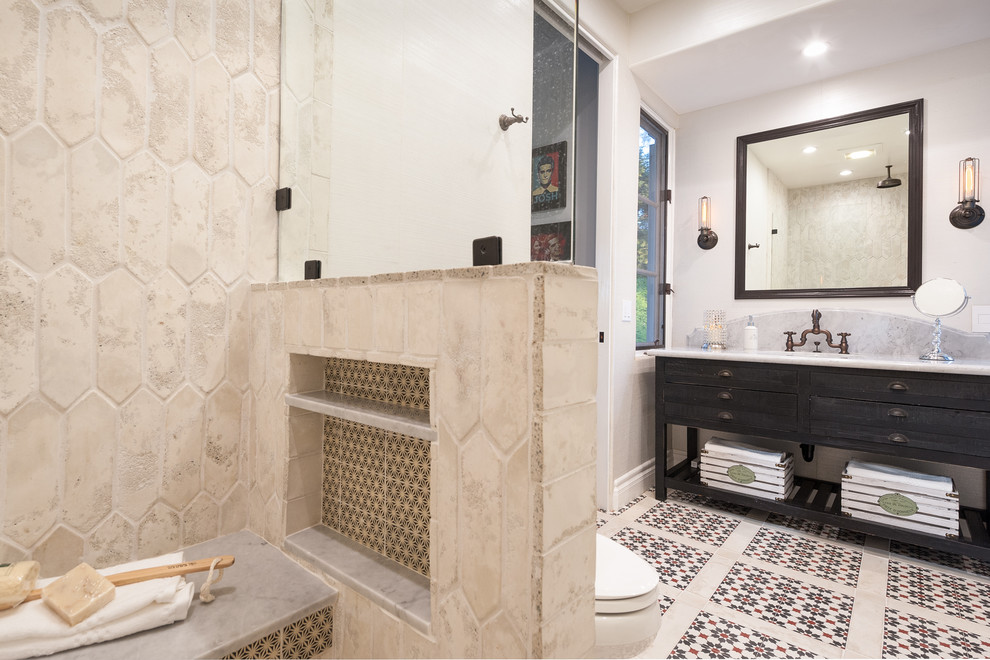 Inspiration for a mid-sized mediterranean bathroom in San Diego with dark wood cabinets, multi-coloured tile, cement tile, concrete floors and marble benchtops.