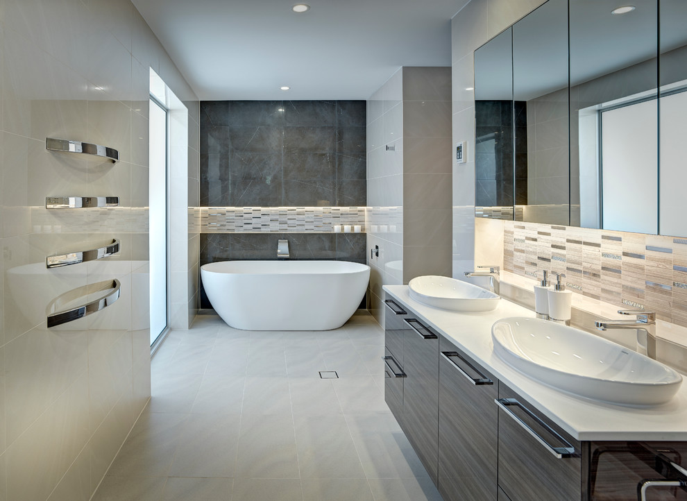 Inspiration for a large contemporary master bathroom in Other with a vessel sink, dark wood cabinets, a freestanding tub, an open shower, beige tile, porcelain tile, beige walls and porcelain floors.