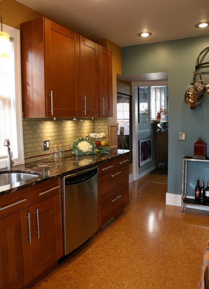 Photo of a small transitional galley eat-in kitchen in Detroit with a single-bowl sink, shaker cabinets, medium wood cabinets, granite benchtops, green splashback, ceramic splashback, stainless steel appliances, cork floors and no island.