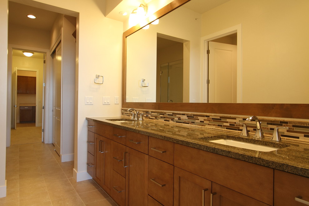 This is an example of a large transitional master bathroom in Denver with medium wood cabinets, granite benchtops, mosaic tile, beige walls, ceramic floors, beige tile, shaker cabinets, an undermount sink and beige floor.