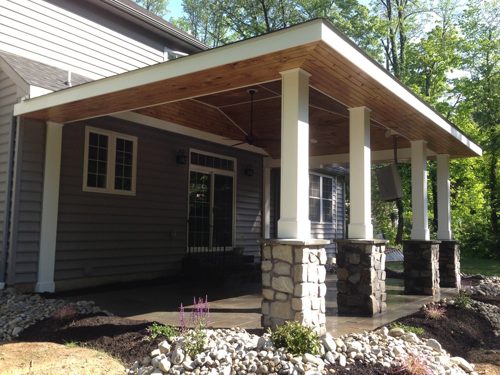 Large traditional white exterior in Philadelphia with stone veneer and a hip roof.