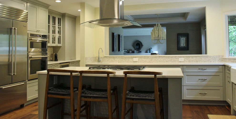 Mid-sized transitional u-shaped dark wood floor eat-in kitchen photo in Seattle with a farmhouse sink, shaker cabinets, gray cabinets, quartzite countertops, gray backsplash, stone tile backsplash, stainless steel appliances and an island