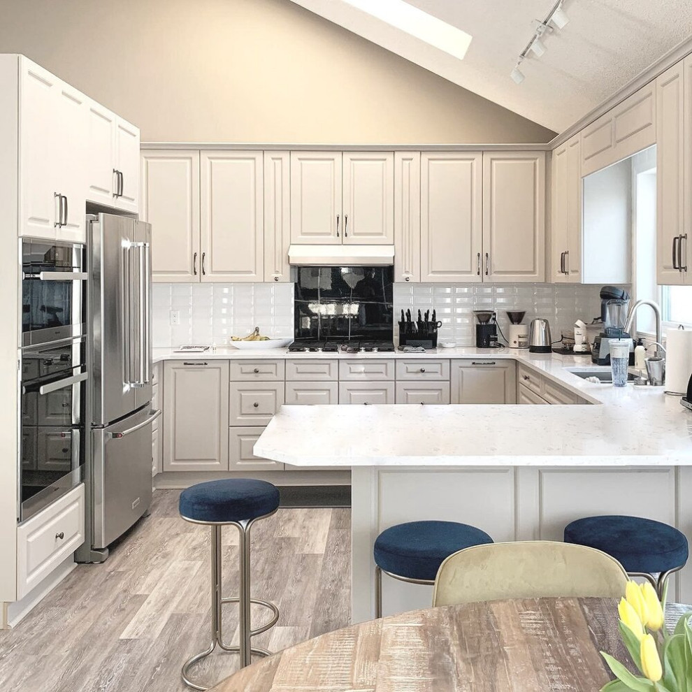 Example of a transitional kitchen design in Calgary