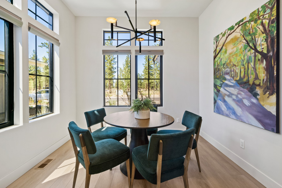 This is an example of a mid-sized contemporary open plan dining in Other with white walls, light hardwood floors and brown floor.
