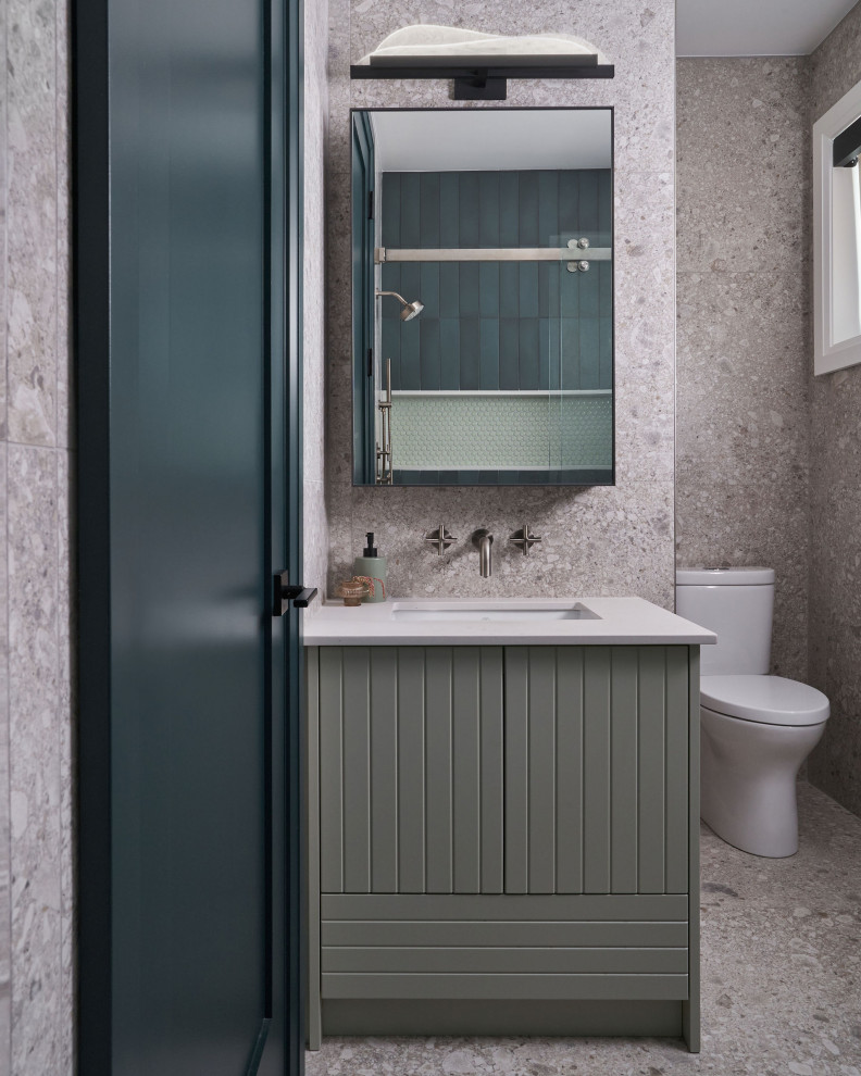Scandinavian family bathroom in Toronto with beaded cabinets, green cabinets, an alcove bath, a one-piece toilet, grey walls, porcelain flooring, a submerged sink, engineered stone worktops, grey worktops and a built in vanity unit.