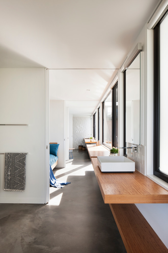 Large contemporary hallway in Melbourne with white walls, concrete floors and grey floor.