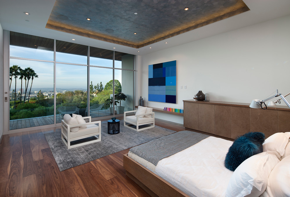 Design ideas for a large contemporary master bedroom in Los Angeles with white walls, dark hardwood floors and no fireplace.