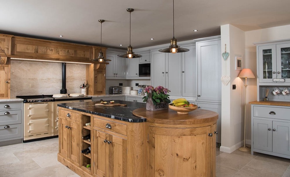 Inspiration for a large country u-shaped open plan kitchen in Other with a drop-in sink, beaded inset cabinets, granite benchtops, beige splashback, stone slab splashback, limestone floors, multiple islands, grey cabinets and coloured appliances.