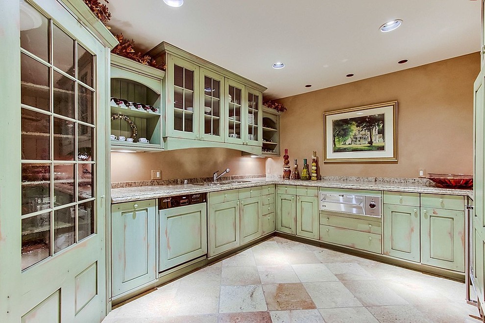 Mid-sized mediterranean l-shaped eat-in kitchen in Salt Lake City with an undermount sink, glass-front cabinets, distressed cabinets, granite benchtops, multi-coloured splashback, stainless steel appliances, travertine floors and no island.