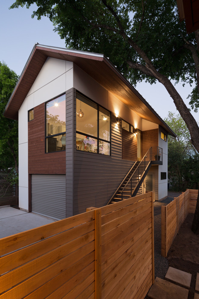 Design ideas for a small transitional two-storey exterior in Austin with concrete fiberboard siding and a gable roof.