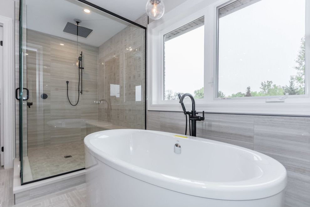 This is an example of a contemporary bathroom in Toronto with shaker cabinets, grey cabinets, gray tile, porcelain tile, grey walls, porcelain floors, engineered quartz benchtops, grey floor and white benchtops.