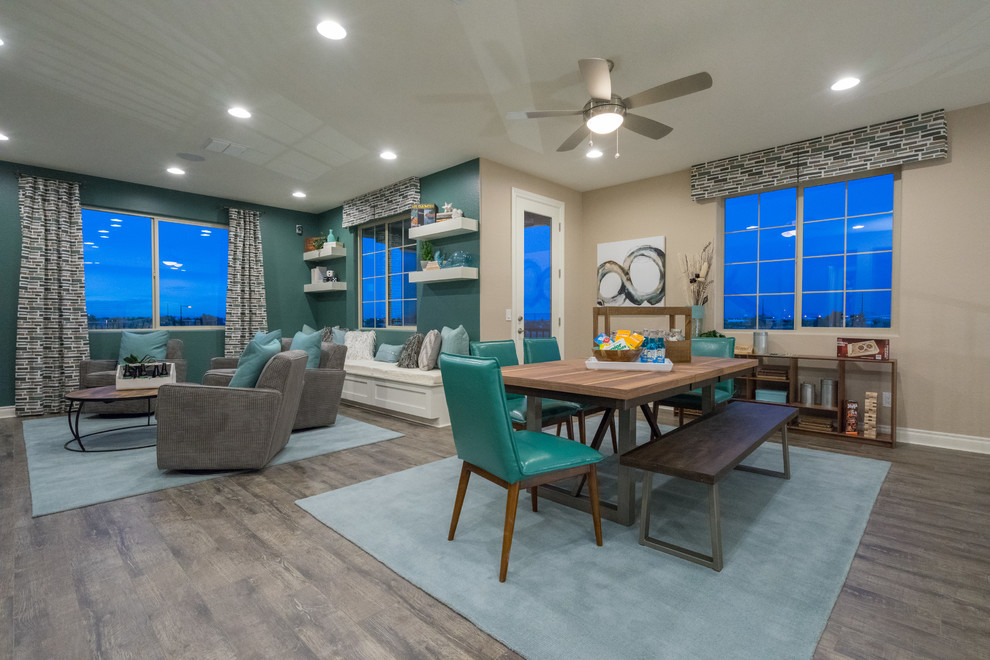 Expansive contemporary loft-style family room in Phoenix with a game room, blue walls, medium hardwood floors, a wall-mounted tv and grey floor.