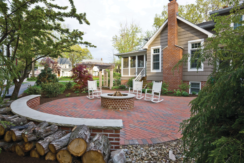 Photo of a traditional patio in Cleveland with a fire feature and brick pavers.
