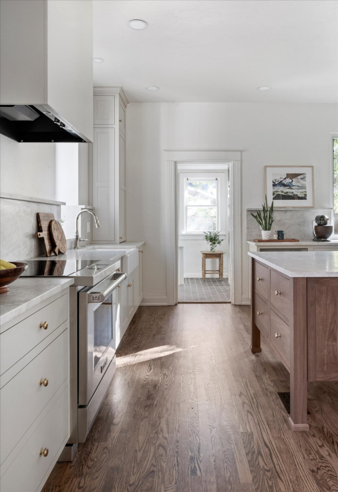 Mid-sized transitional medium tone wood floor and brown floor eat-in kitchen photo in Denver with white walls and a standard fireplace