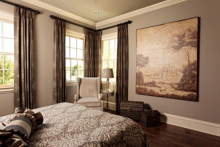 Photo of a transitional guest bedroom in Dallas with brown walls, medium hardwood floors and brown floor.