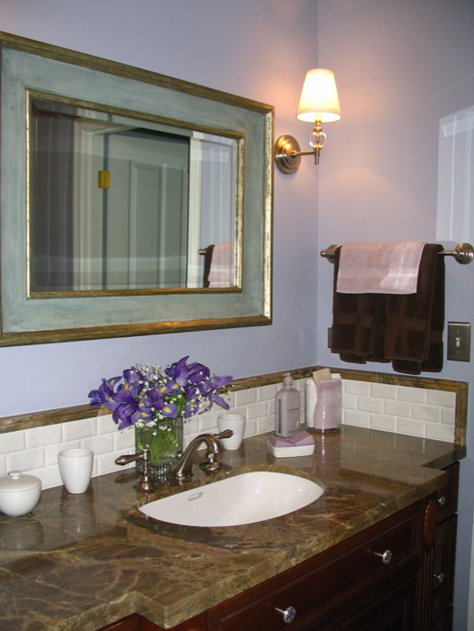 Transitional bathroom in New York with furniture-like cabinets, dark wood cabinets, marble benchtops, brown tile and purple walls.