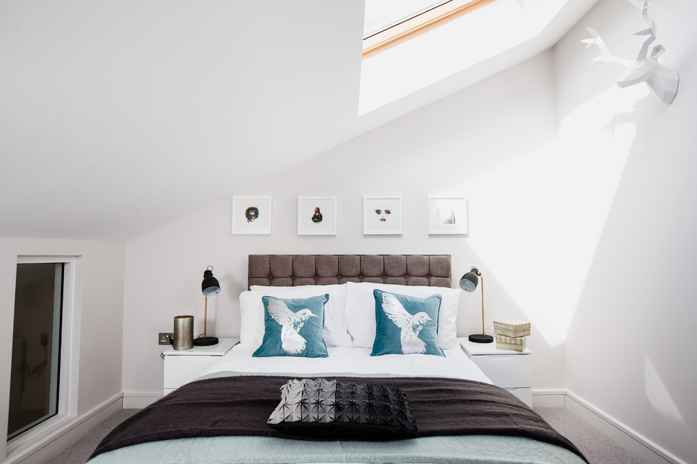 Photo of a transitional bedroom in London with white walls and carpet.